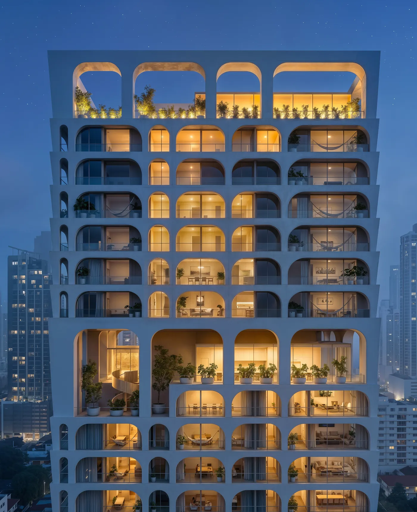 Fachada frontal de BLUR de noche, con cada apartamento iluminado tras sus arcos